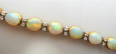 Lot 573 - An 18 Carat Gold Opal and Diamond Bracelet, articulated links of oval cabochon opals in yellow...