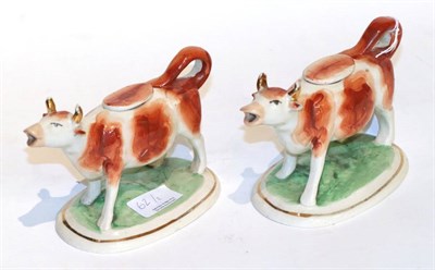 Lot 62 - A pair of cow creamers