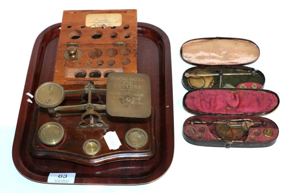 Lot 63 - A set of small postal scales; two toleware cased scales; and a cased set of weights