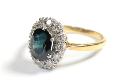 Lot 71 - A sapphire and diamond cluster ring, finger size M