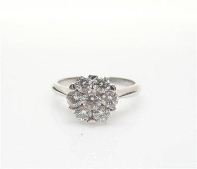 Lot 576 - An 18 Carat White Gold Diamond Cluster Ring, seven round brilliant cut diamonds in white claw...