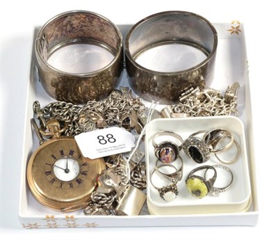 Lot 88 - Three silver charm bracelets; eight silver and white metal rings; two unmarked bangles; and a...