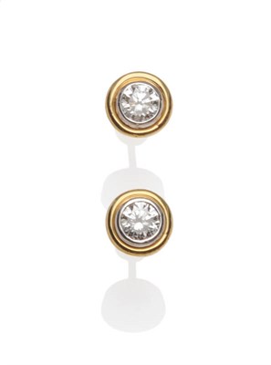 Lot 577 - A Pair of Diamond Solitaire Stud Earrings, a round brilliant cut diamond in a white rubover setting