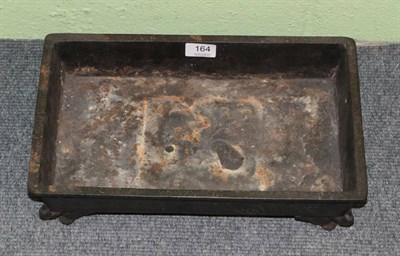 Lot 164 - A Japanese Meiji period cast iron planter of shallow rectangular form, relief decorated with...