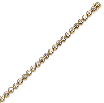 Lot 585 - A Diamond Line Bracelet, twenty-six round brilliant cut diamonds in white and yellow rubover...