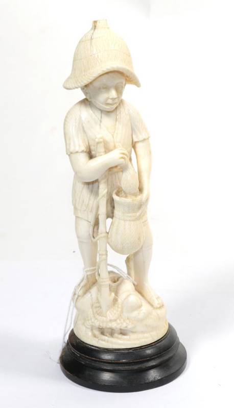 Lot 194 - A carved marine ivory figure of a man holding a fish and with spear, early 20th century