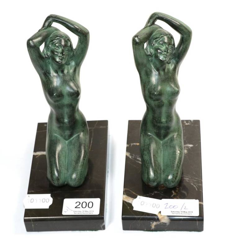Lot 200 - A pair of green patinated bronze female nude bookends, probably French, in the manner of Max le...