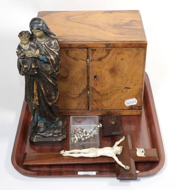 Lot 220 - A carved ivory crucifix probably French, late 19th century, an olive wood two drawer table cabinet