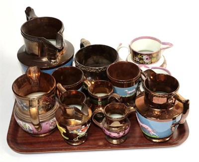 Lot 225 - A group of 19th century copper lustre jugs, mugs and beakers, many examples relief moulded with...