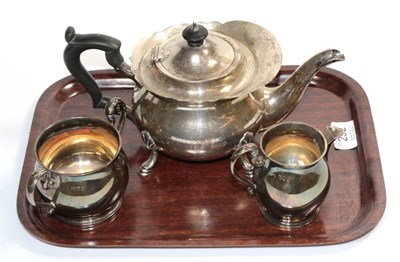 Lot 232 - A silver teapot, London, 1922; together with a matched sugar bowl and cream jug, London...