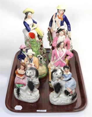 Lot 233 - A group of Staffordshire figures, to include: a huntsman and wife; two cavalier type figures; a...