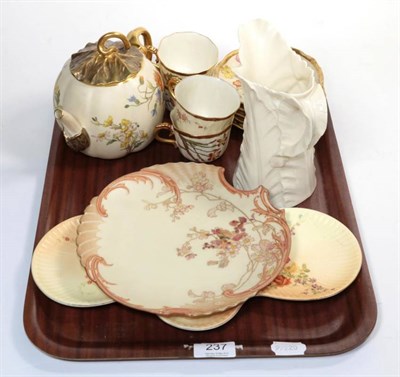 Lot 237 - A Royal Worcester blush ivory melon form teapot, four similar teacups and saucers, two dishes and a