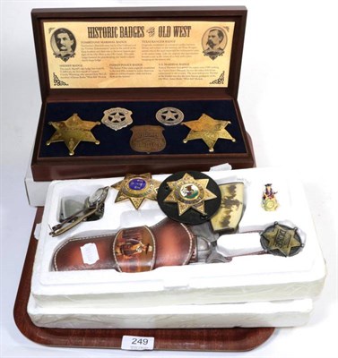 Lot 249 - A model of a revolver, boxed; a cased set of Sheriff's badges; two wristwatches; and a...