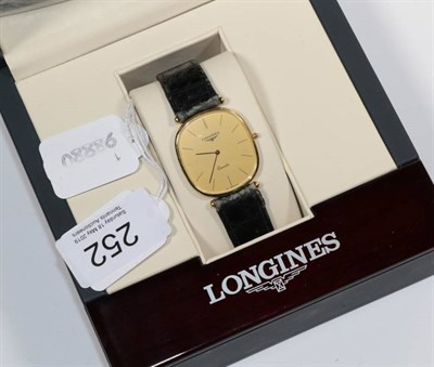 Lot 252 - An 18ct gold wristwatch, signed Longines, circa 1985, quartz movement, champagne coloured dial with