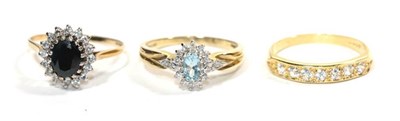 Lot 264 - Two 9 carat gold dress rings, finger sizes R1/2 and S; and an 18 carat gold seven stone ring,...
