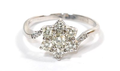 Lot 279 - A diamond flower head cluster ring, stamped '750', finger size S
