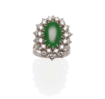 Lot 597 - A Jade and Diamond Cluster Ring, an oval cabochon jade within a double border of round...