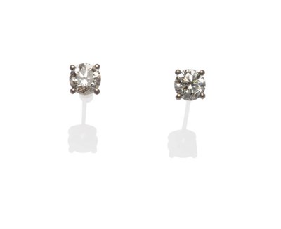 Lot 598 - A Pair of 18 Carat White Gold Diamond Solitaire Stud Earrings, a round brilliant cut diamond...