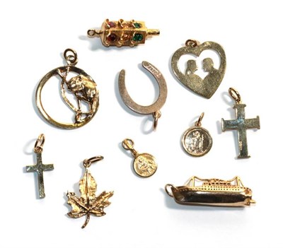 Lot 310 - Six 9 carat gold charms/pendants including a ship, two crosses etc; and four charms/pendants...