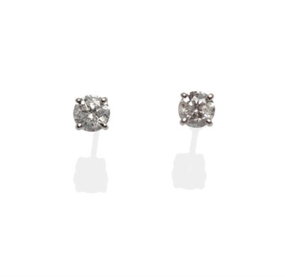 Lot 601 - A Pair of 18 Carat White Gold Diamond Solitaire Stud Earrings, the round brilliant cut diamonds...