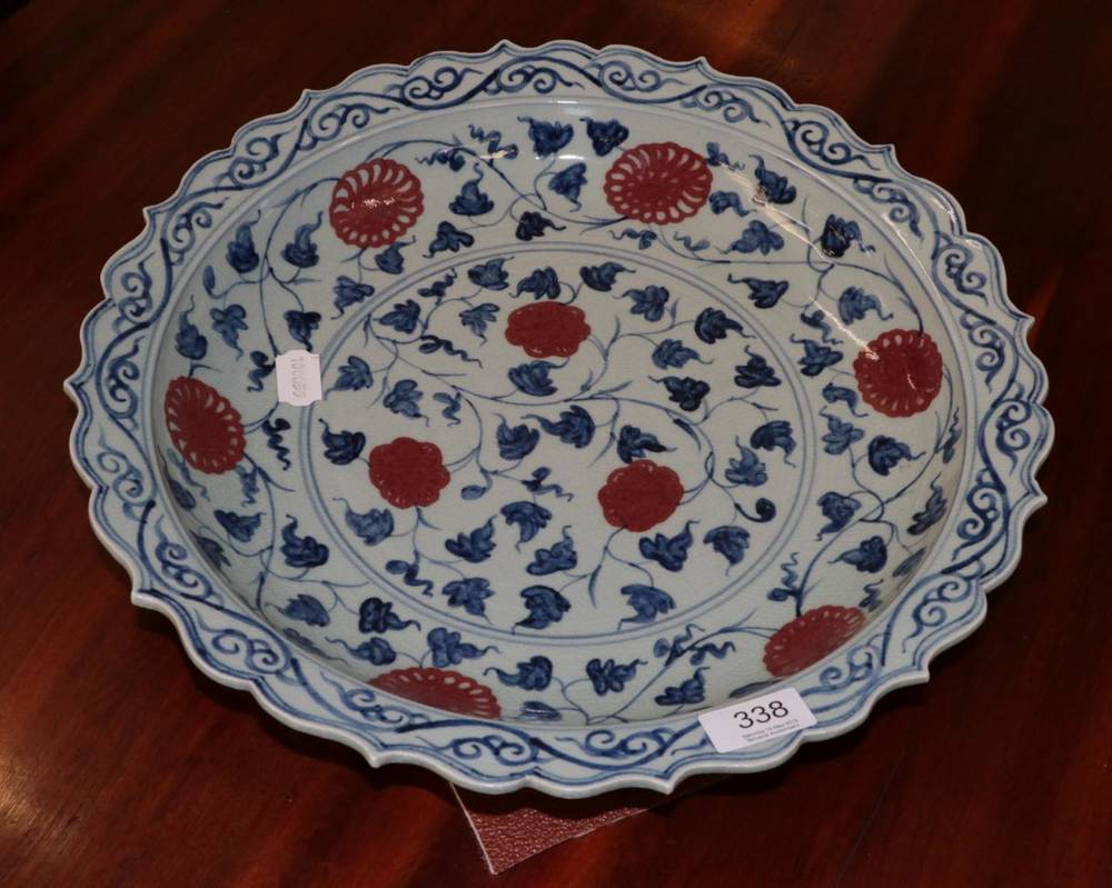 Lot 338 - A Chinese porcelain shallow dish decorated with scrolling foliage in the Ming style