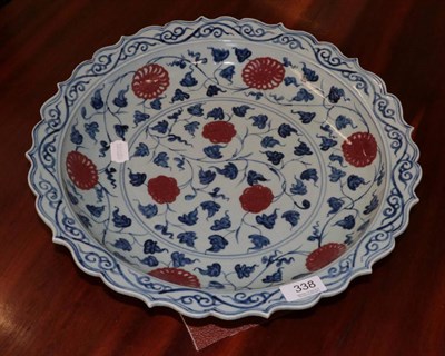 Lot 338 - A Chinese porcelain shallow dish decorated with scrolling foliage in the Ming style