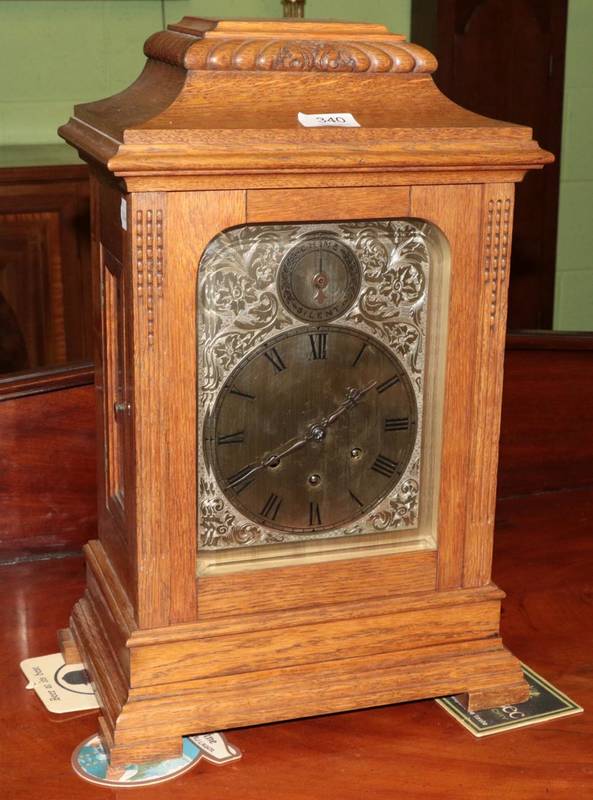 Lot 340 - An oak chiming mantle clock with silvered dial, the movement signed Gustav Becker