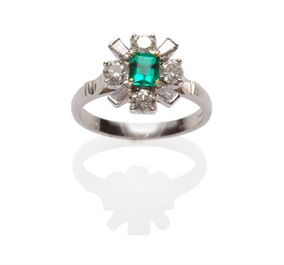 Lot 602 - An 18 Carat White Gold Emerald and Diamond Cluster Ring, an emerald-cut emerald within a border...