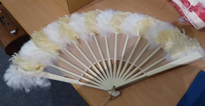 Lot 1002 - An Edwardian ivory handled folding parasol with pink silk mount; two fans; Liberty pink floral...