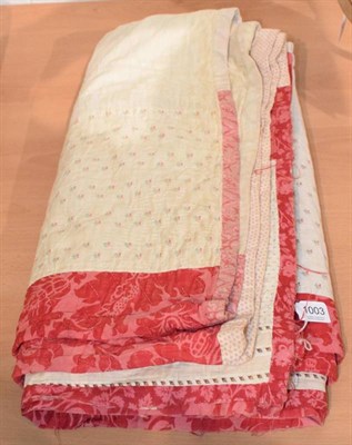 Lot 1003 - Late 19th century strippy quilt, incorporating red and pink floral cotton strips alternating...