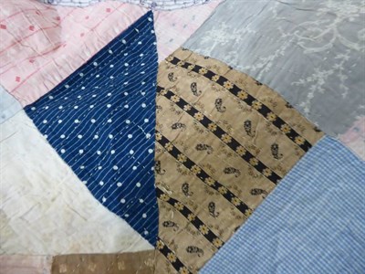 Lot 1012 - Late 19th century medallion patchwork quilt, worked in patches of pale pink, blue, red, cream...