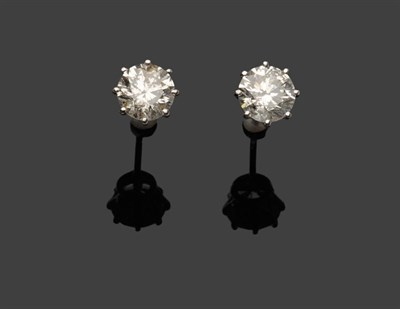 Lot 606 - A Pair of Diamond Solitaire Stud Earrings, the round brilliant cut diamonds held in white eight...