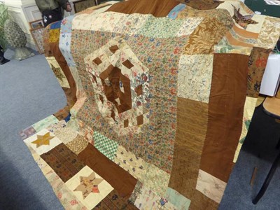 Lot 1056 - An early 20th century patchwork quilt with patched stars, central hexagonal motif patched with...