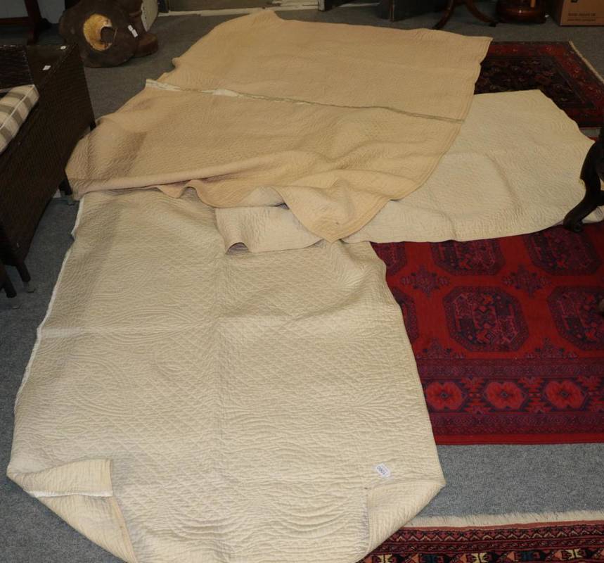 Lot 1060 - Pair of early 20th century north country cream whole cloth single quilts, reversible, with...