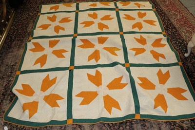Lot 1061 - Large early 20th century American patchwork quilt, incorporating large four petalled yellow...