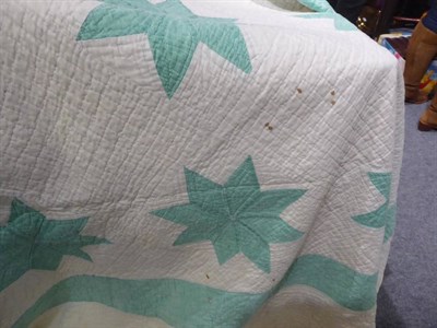 Lot 1081 - Early 20th century patchwork quilt, with pale green stars appliqued on a white ground within a...