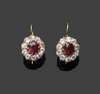 Lot 612 - A Pair of Ruby and Diamond Cluster Earrings, the oval mixed cut rubies within a border of old...