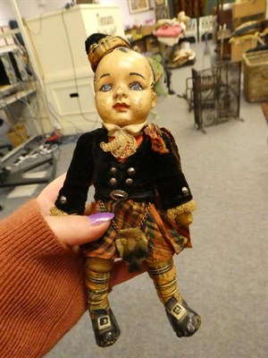 Lot 1088 - A 19th century wax doll with blue glass eyes, teddy in blue military uniform, hide covered...