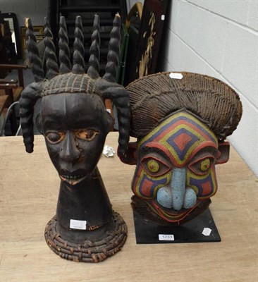 Lot 1233 - A Bamileke, Gabon beadwork decorated mask with raffia coiffure; an Ekoi type skin covered crest...