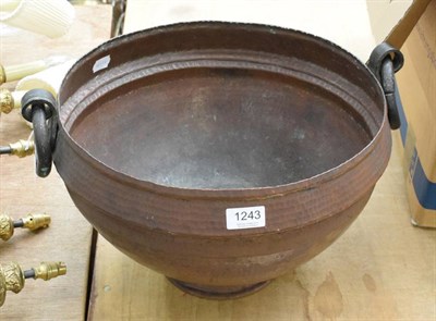 Lot 1243 - A copper twin handled planter with hammered decoration