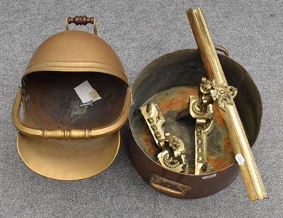 Lot 1263 - A large twin-handled copper pan, a brass copper coal helmet and a pair of andirons