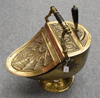 Lot 1266 - A Victorian brass coal scuttle with integral shovel, heavily embossed