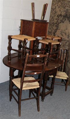 Lot 1270 - A group of stools; rush seated chairs and a carved oak side table (7)