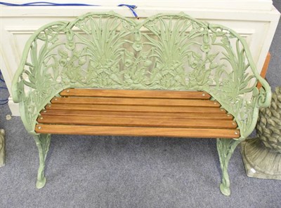 Lot 1287 - A green painted Coalbrookedale style cast iron and wooden slatted garden bench