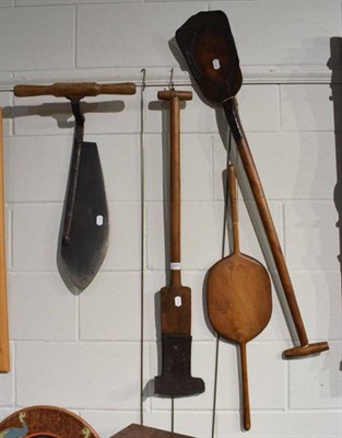 Lot 1293 - A 19th century metal tipped peat shovel, a similar shovel, a hay cutter and another treen implement