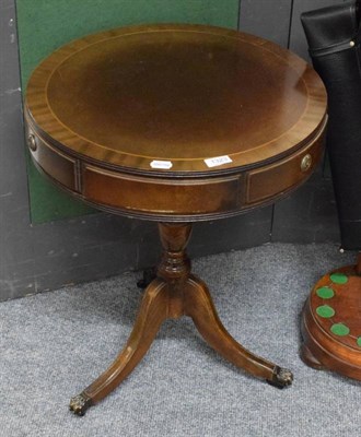 Lot 1323 - A reproduction Regency style drum side table with drawers