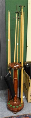 Lot 1324 - A snooker cue stand and seven cues