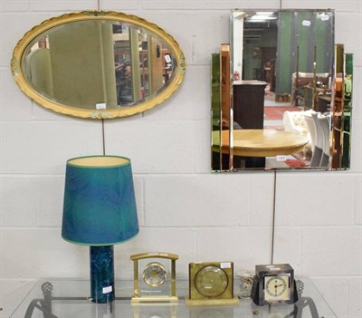 Lot 1326 - An Art Deco style mirror; a 1960's/70's table lamp; three clocks; and an oval mirror (6)