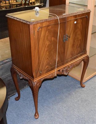 Lot 1369 - A figured walnut two-door cocktail cabinet on cabriole legs and pad feet