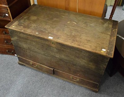 Lot 1373 - An oak chest with hinged top and two lower drawers